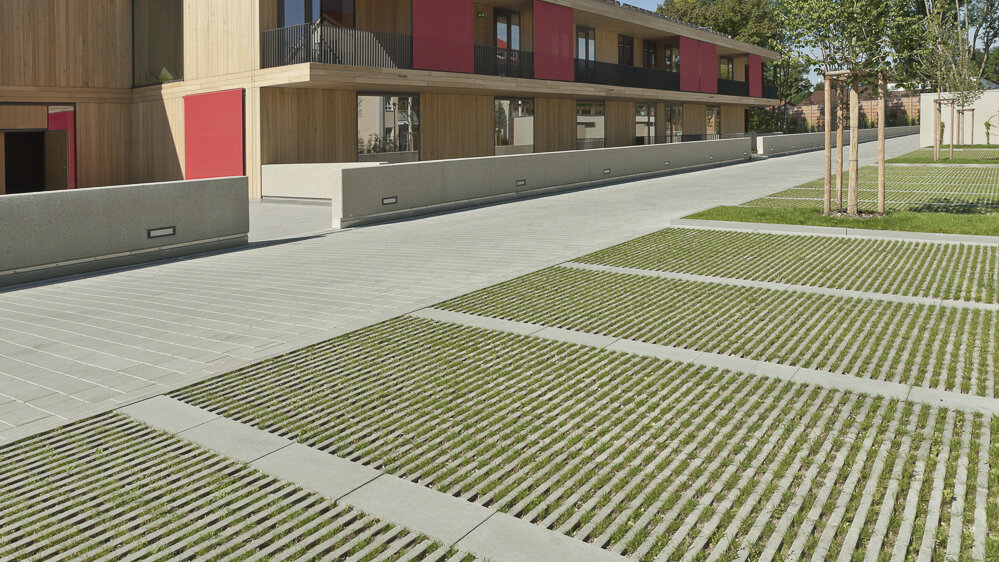 Hydropor KL-Grünfugenplatte in Standard Grau Parkplätze vor einem Gebäuse mit Hydropor KL-Grünfugenplatte in Standard Grau